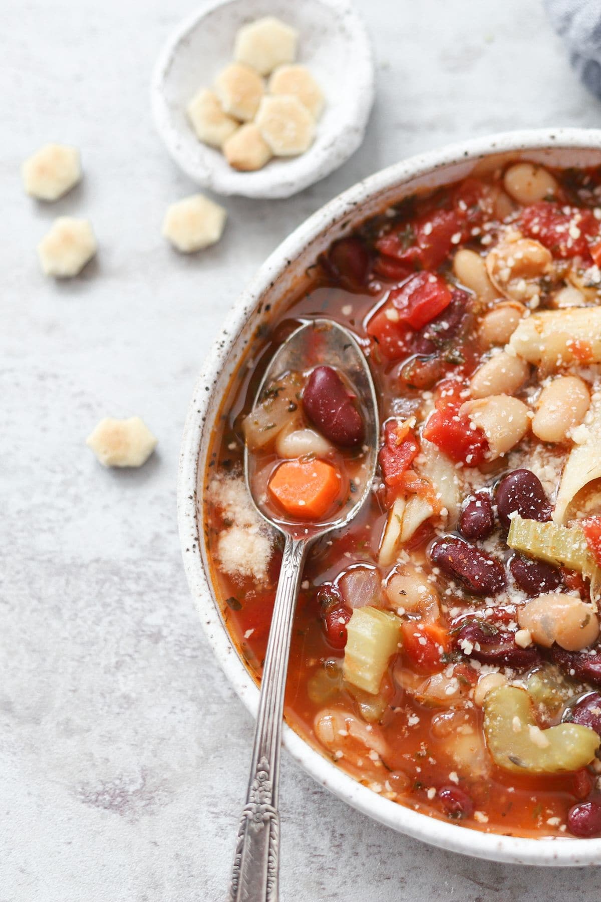 A bowl of easy minestrone soup with a spoonful of warm hearty broth.