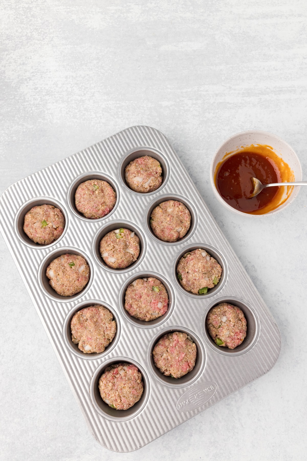 meatloaf muffins in a muffin tin, uncooked
