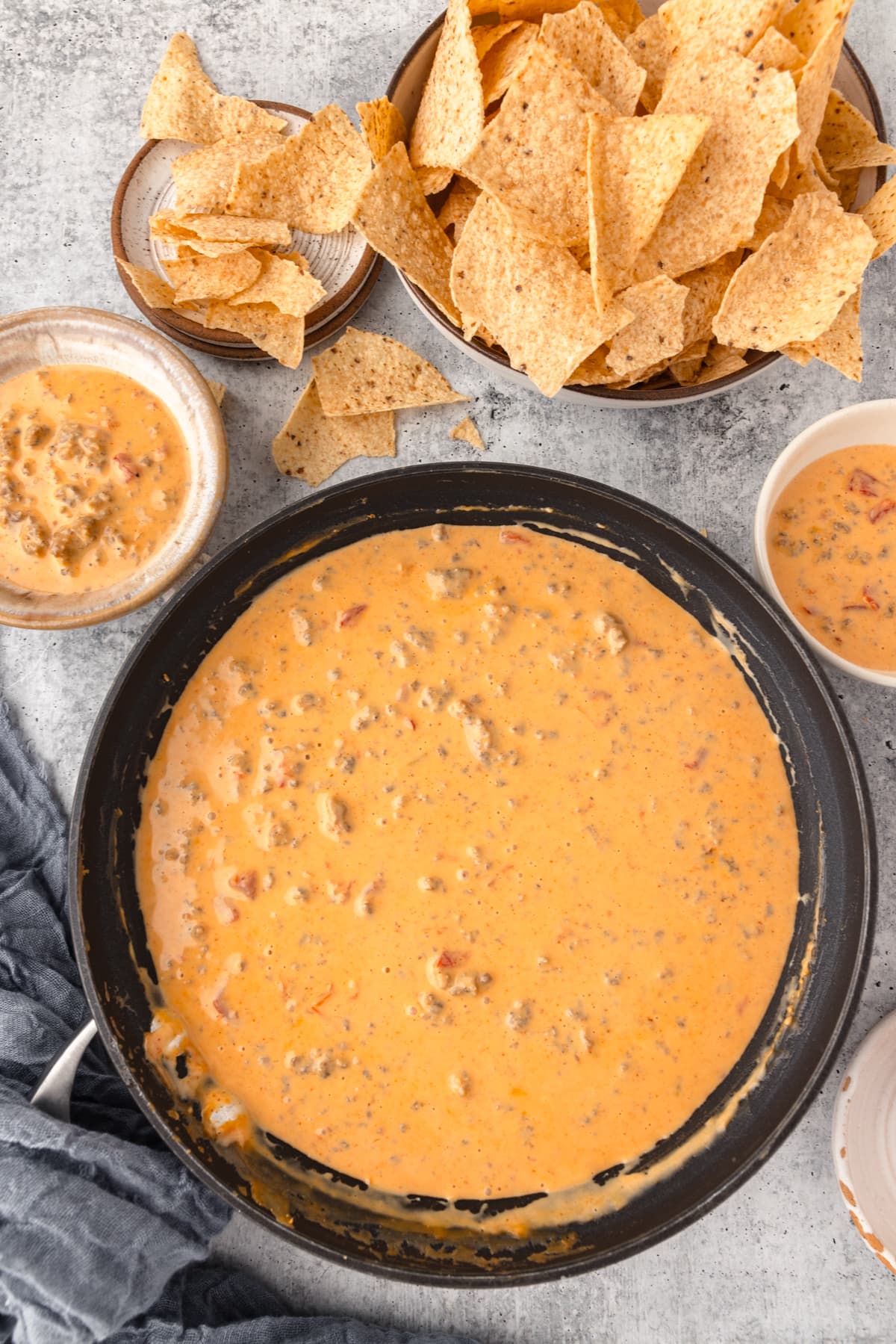 a Skillet full of melted cheese served alongside tortilla chips