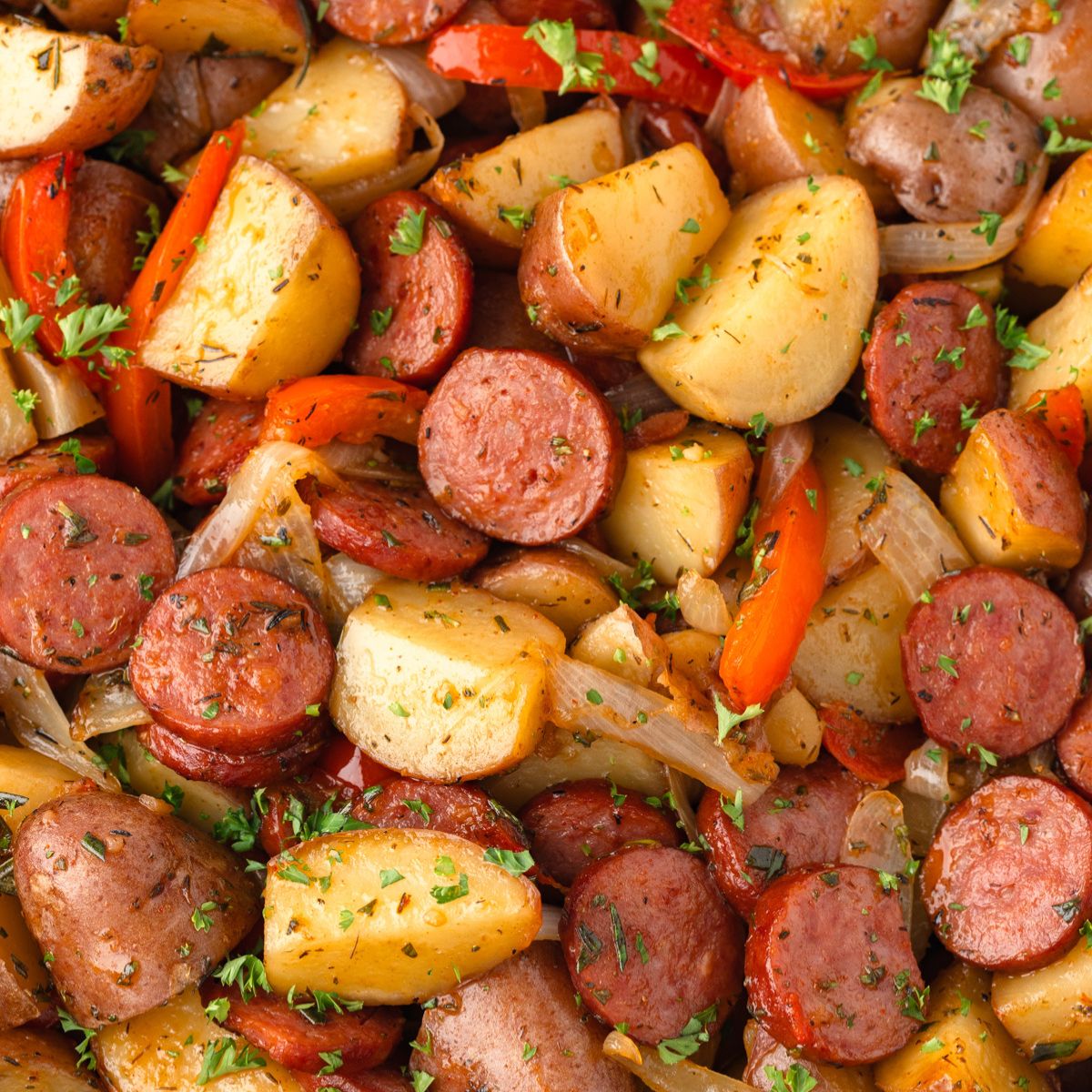 Smoked sausage and potatoes in a cast iron skillet.