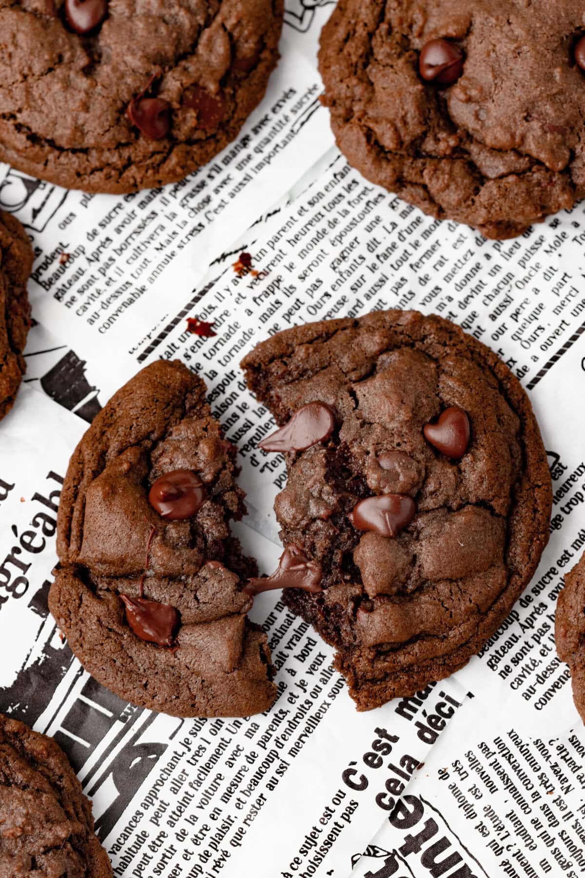 Gooey chocolate chip cookies on newspaper background, delicious homemade dessert.