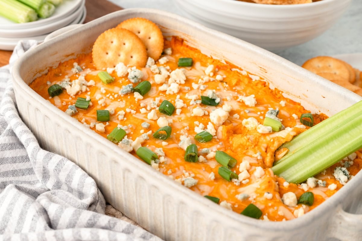 Cheesy buffalo chicken casserole topped with green onions and blue cheese crumbles.