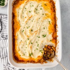 Shepherd's Pie with mashed potatoes and savory beef filling, topped with herbs.
