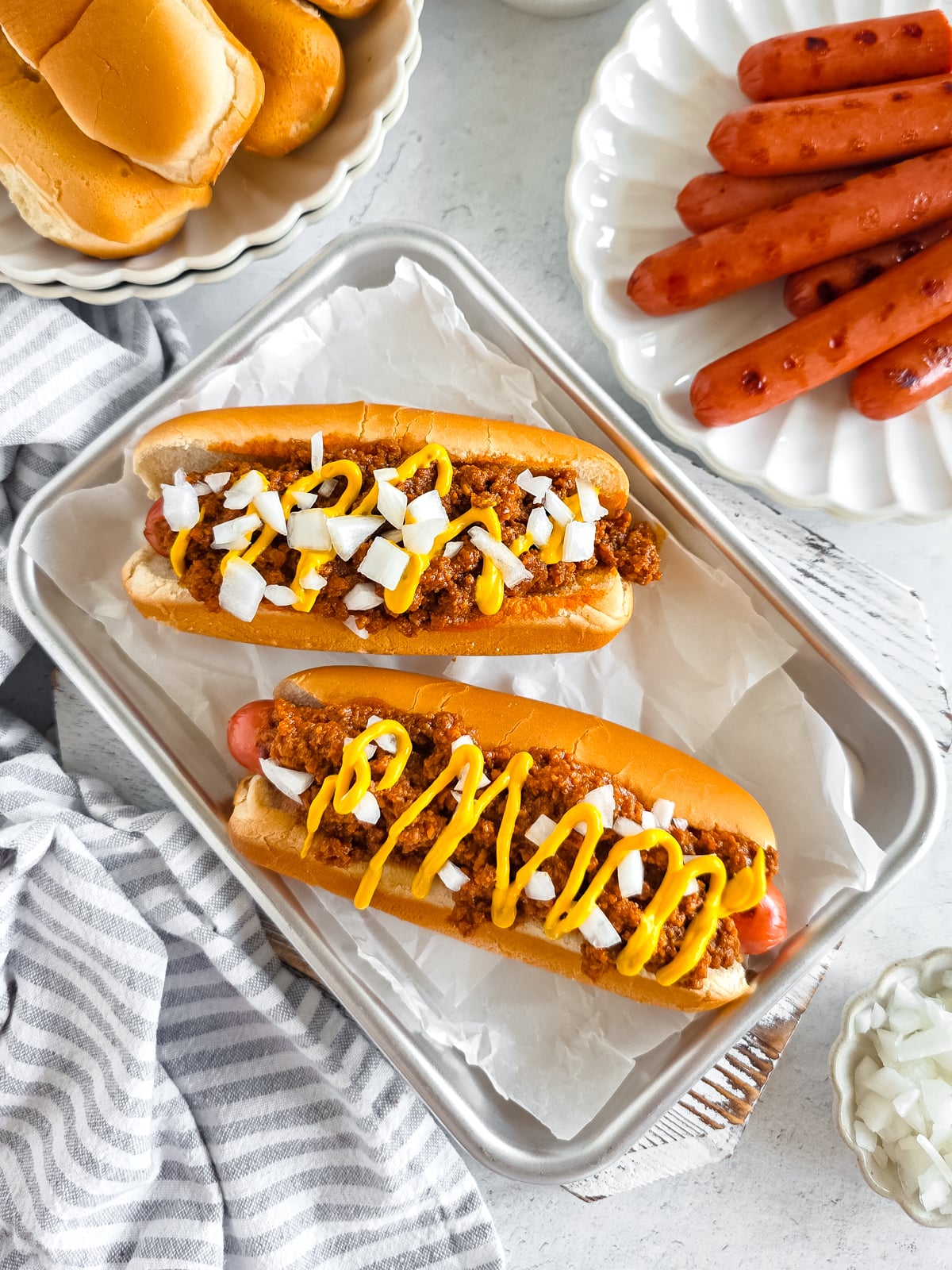A delicious hot dog with savory sauce and toppings in a soft bun.
