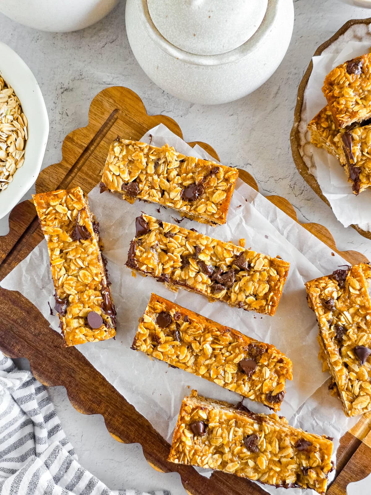 Chewy Einkorn Granola Bars with oats and chocolate chips, on parchment paper.