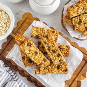 Chewy Einkorn Granola Bars with oats and chocolate chips on a wooden board.