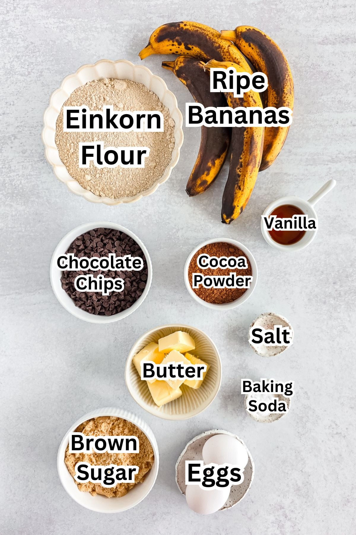 Creamy banana bread ingredients with ripe bananas, flour, chocolate chips, cocoa powder, eggs, butte.