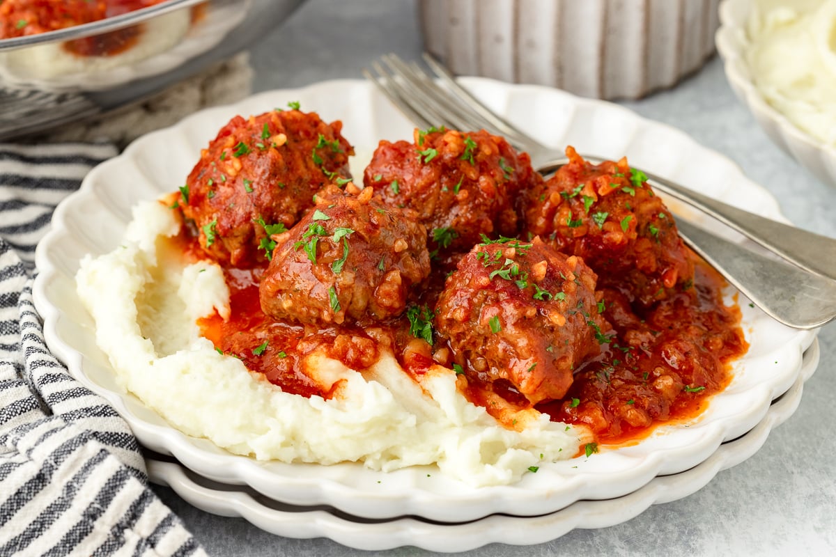 Porcupine Meatballs with tomato sauce served over mashed potatoes.