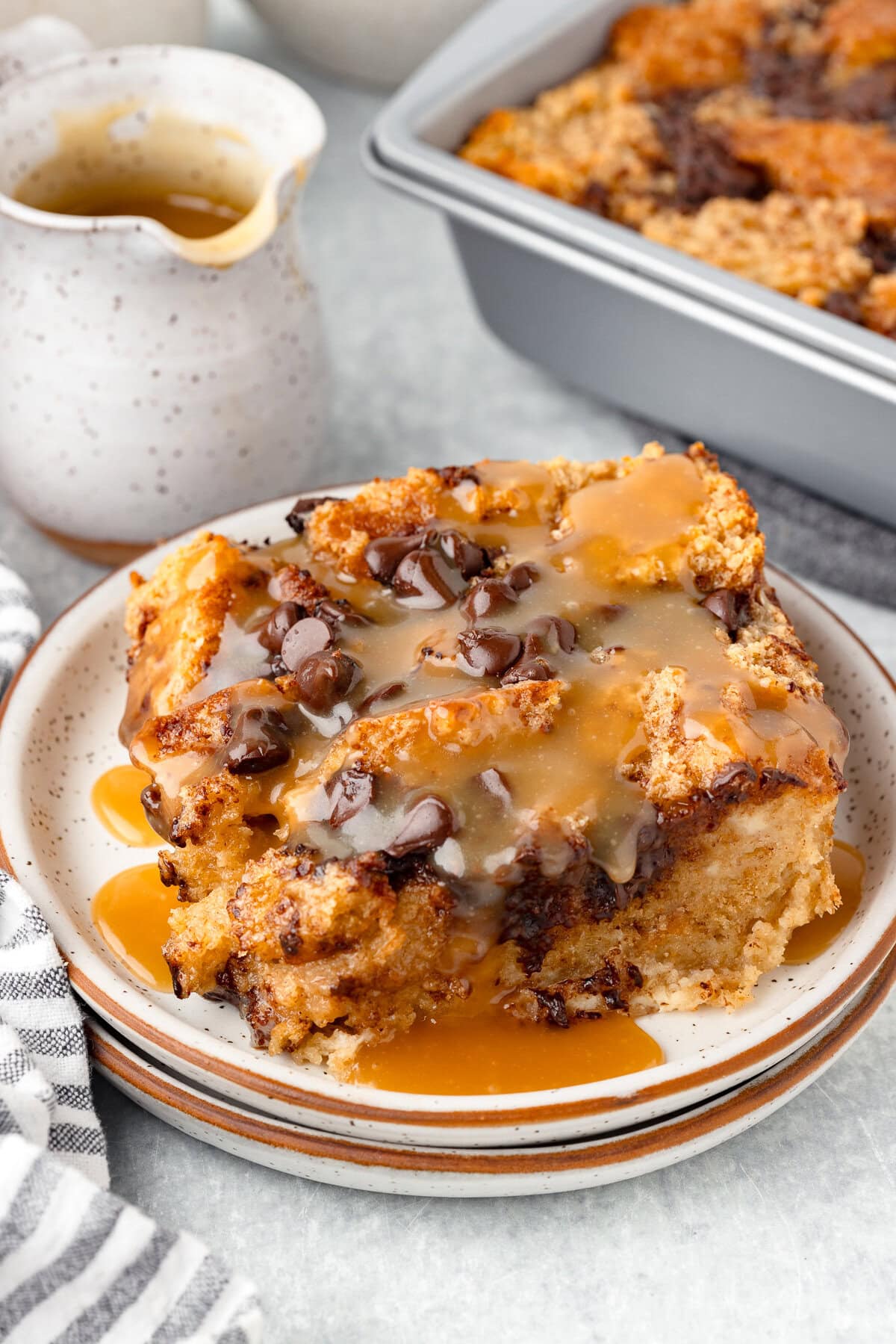 Biscuit bread pudding with caramel sauce and chocolate chips, baked and creamy.