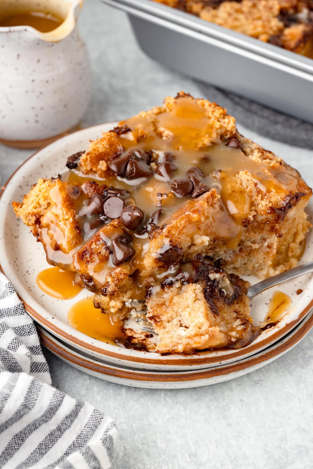 Biscuit bread pudding with caramel sauce and chocolate chips, baked and creamy.