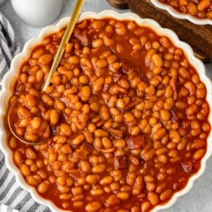 Crock Pot Baked Beans in a round scalloped bowl.
