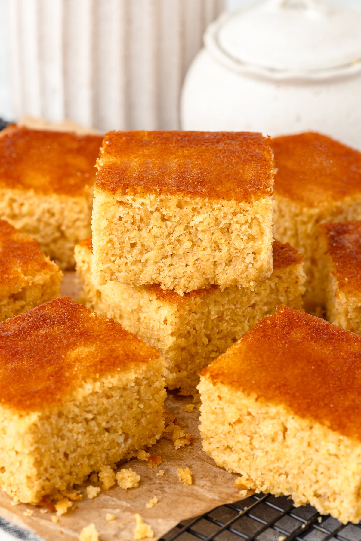 Fresh Milled Flour Cornbread cut into squares, on brown parchment paper.