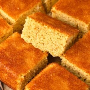 Fresh Milled Flour Cornbread cut into thick squares on a plate.