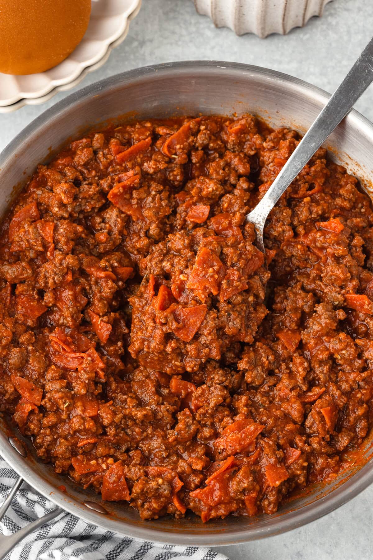 Hearty sloppy joe filling with ground beef and tomato in a skillet.