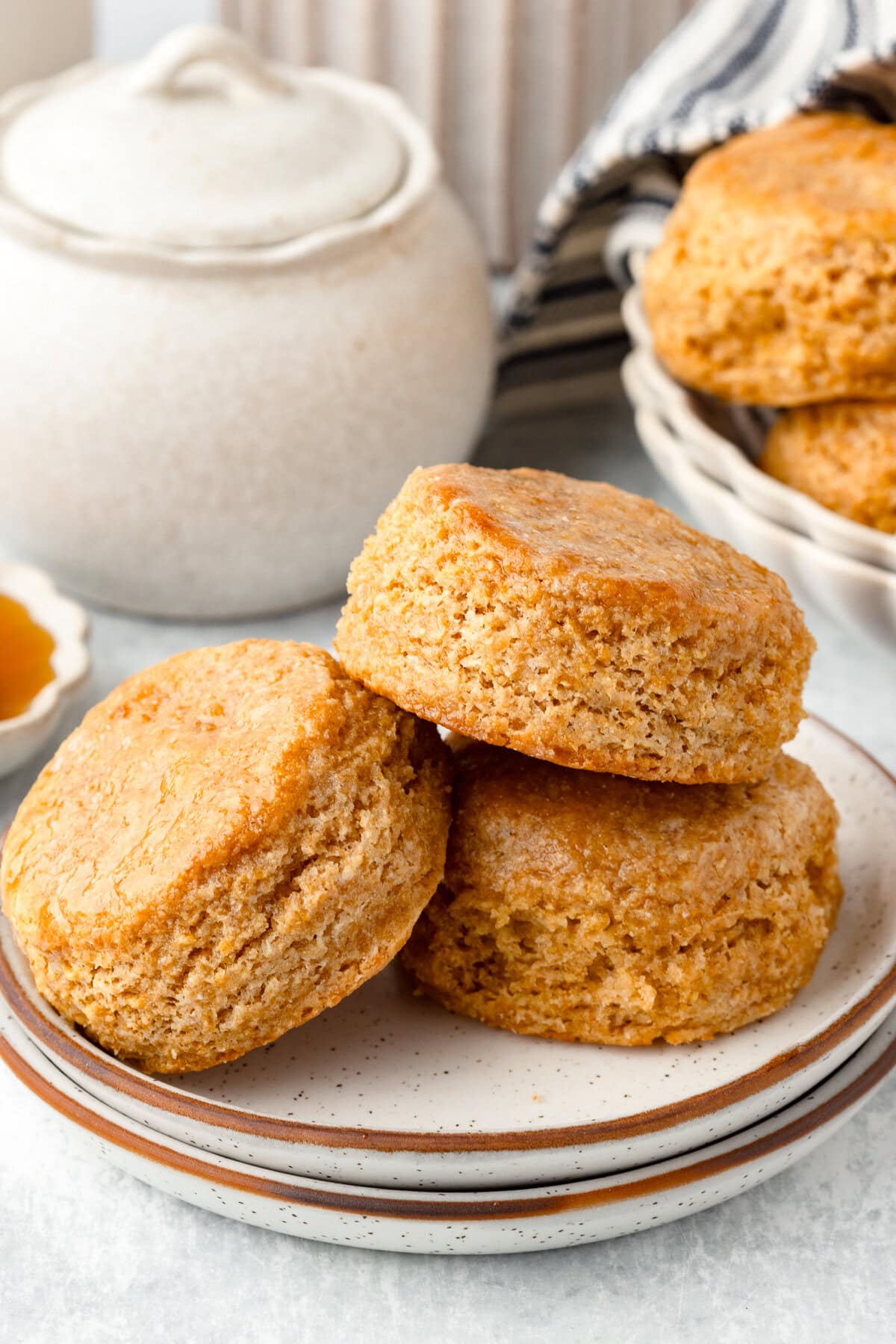 Whole wheat biscuits with a golden crust and fluffy interior on a plate.