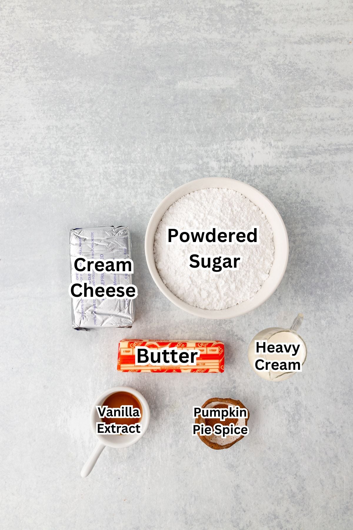 Ingredients to make pumpkin spice cream cheese frosting.